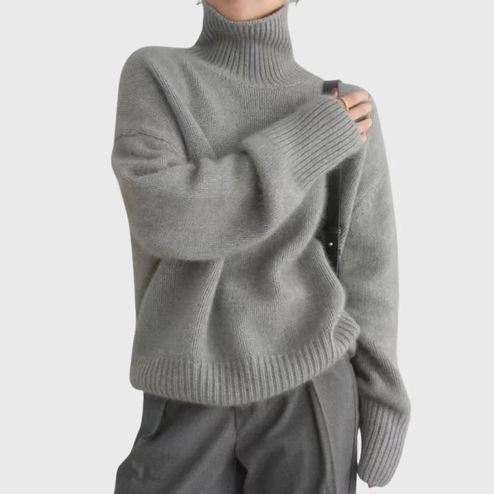 Side view of relaxed fit turtleneck jumper with drop shoulders and clean minimal silhouette