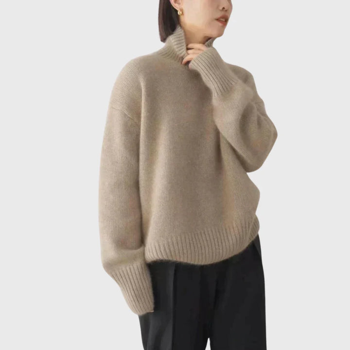 Detail of extended ribbed cuffs on women's turtleneck jumper with neat structured finish