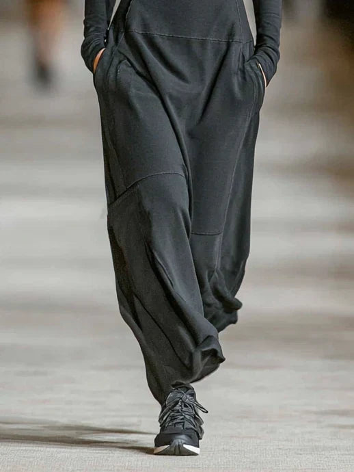 Side view of women's track maxi dress with flowing skirt and side pockets