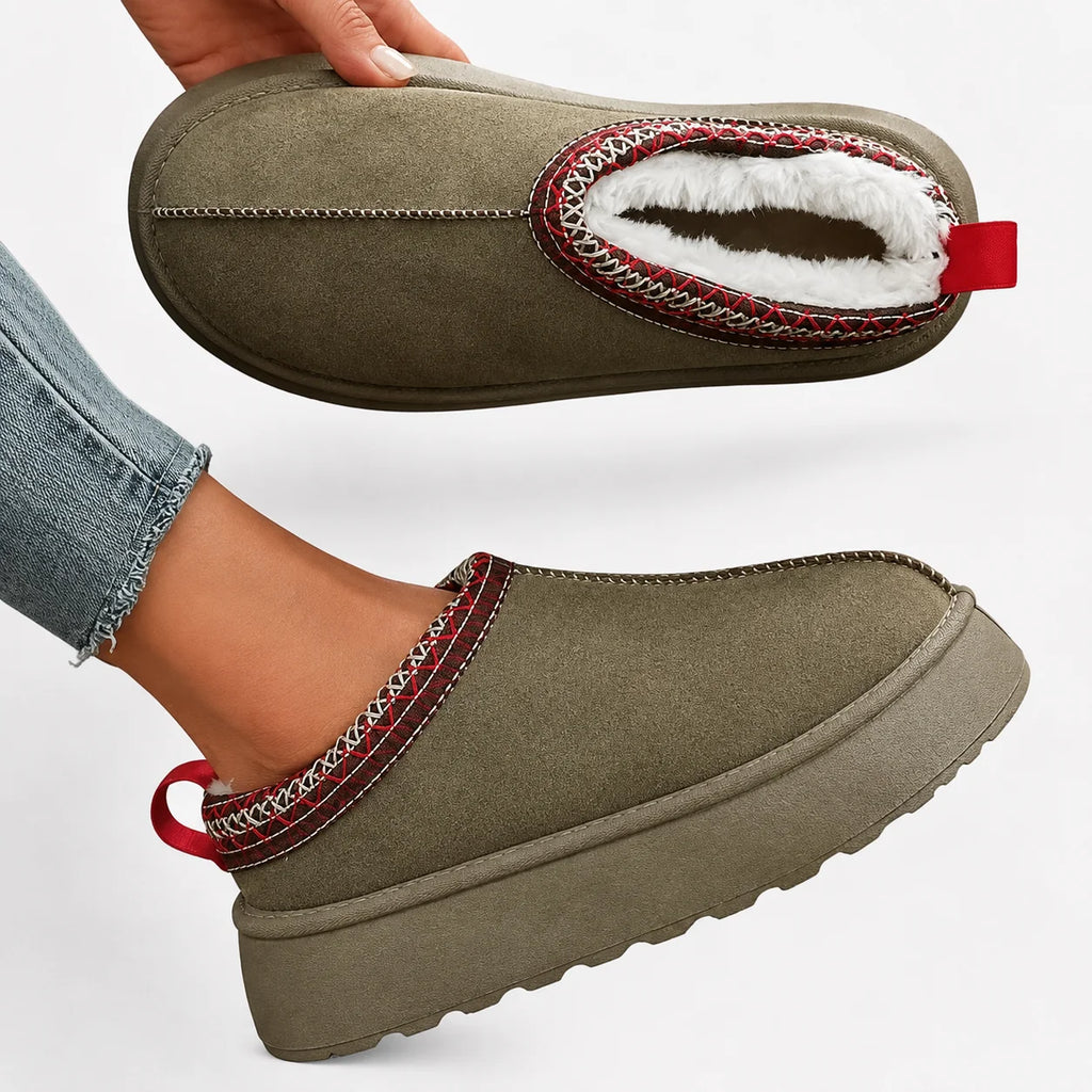 Close-up of women's olive faux suede slippers showing fleece lining and platform sole detail