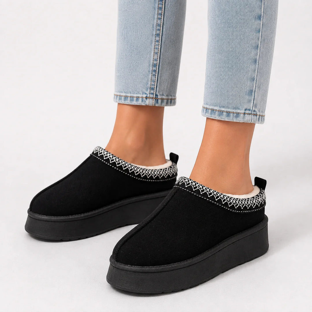 Women's faux suede slippers in olive featuring woven trim and closed-toe design for winter wear