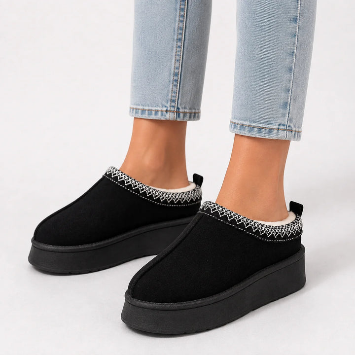 Women's faux suede slippers in olive featuring woven trim and closed-toe design for winter wear