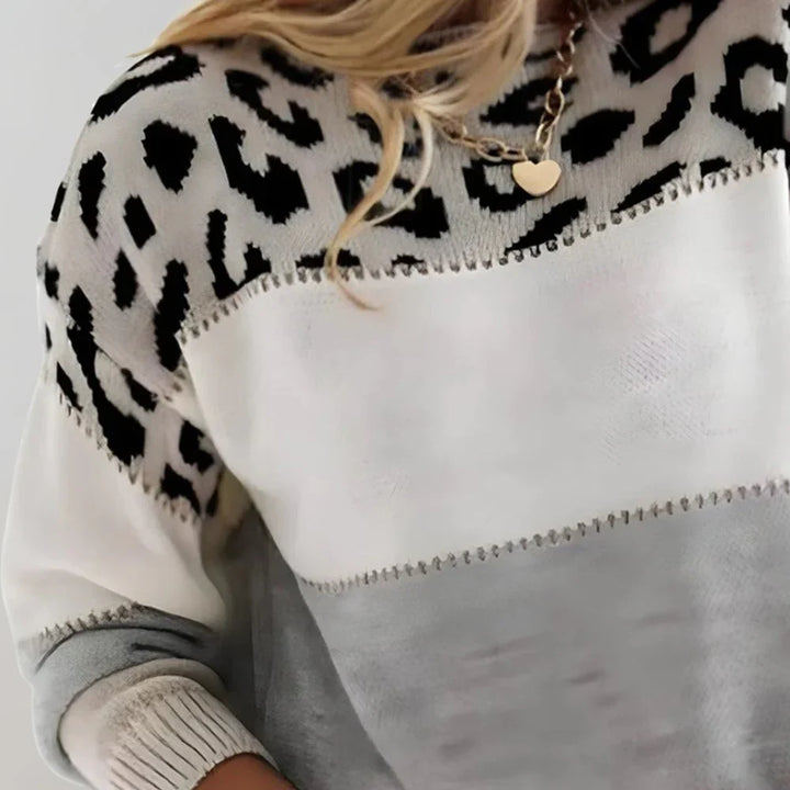 Close-up view of leopard print yoke and colour block design on women's relaxed fit jumper