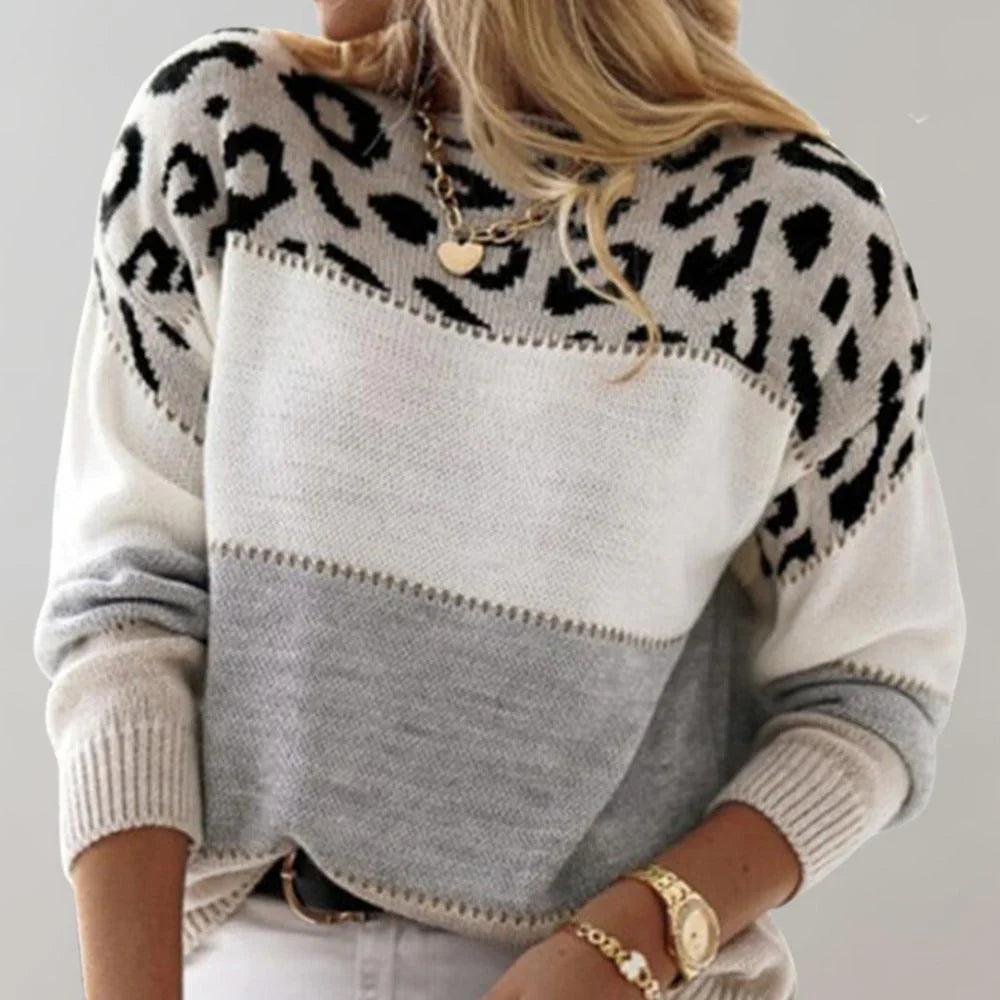 Side angle of women's leopard print jumper showing drop shoulder seams and ribbed cuffs