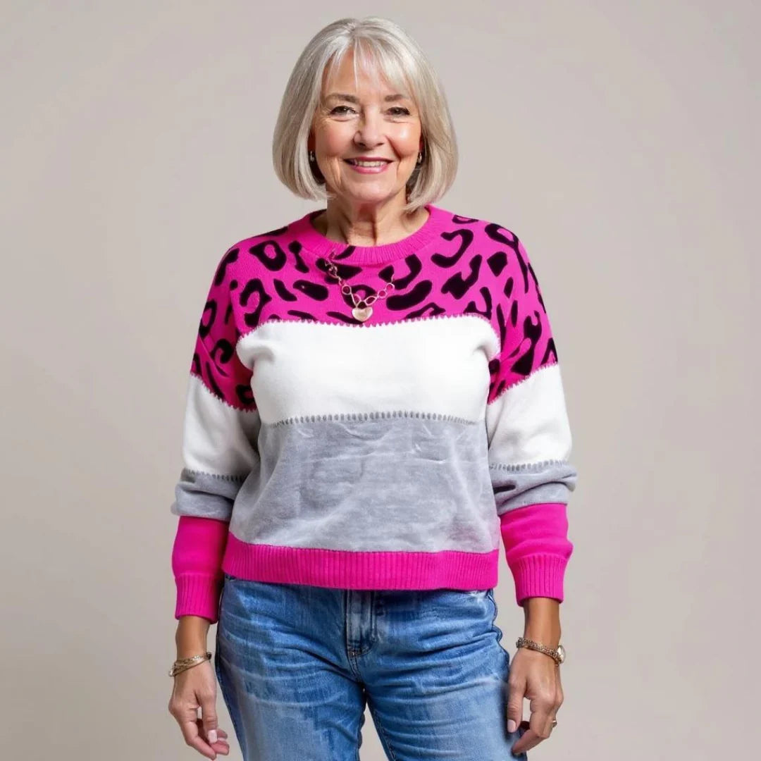 Full outfit featuring leopard print jumper paired with white trousers and black handbag