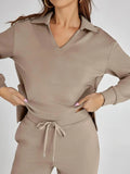 Taupe two-piece lounge set featuring relaxed fit top and wide leg trousers with drawstring waist