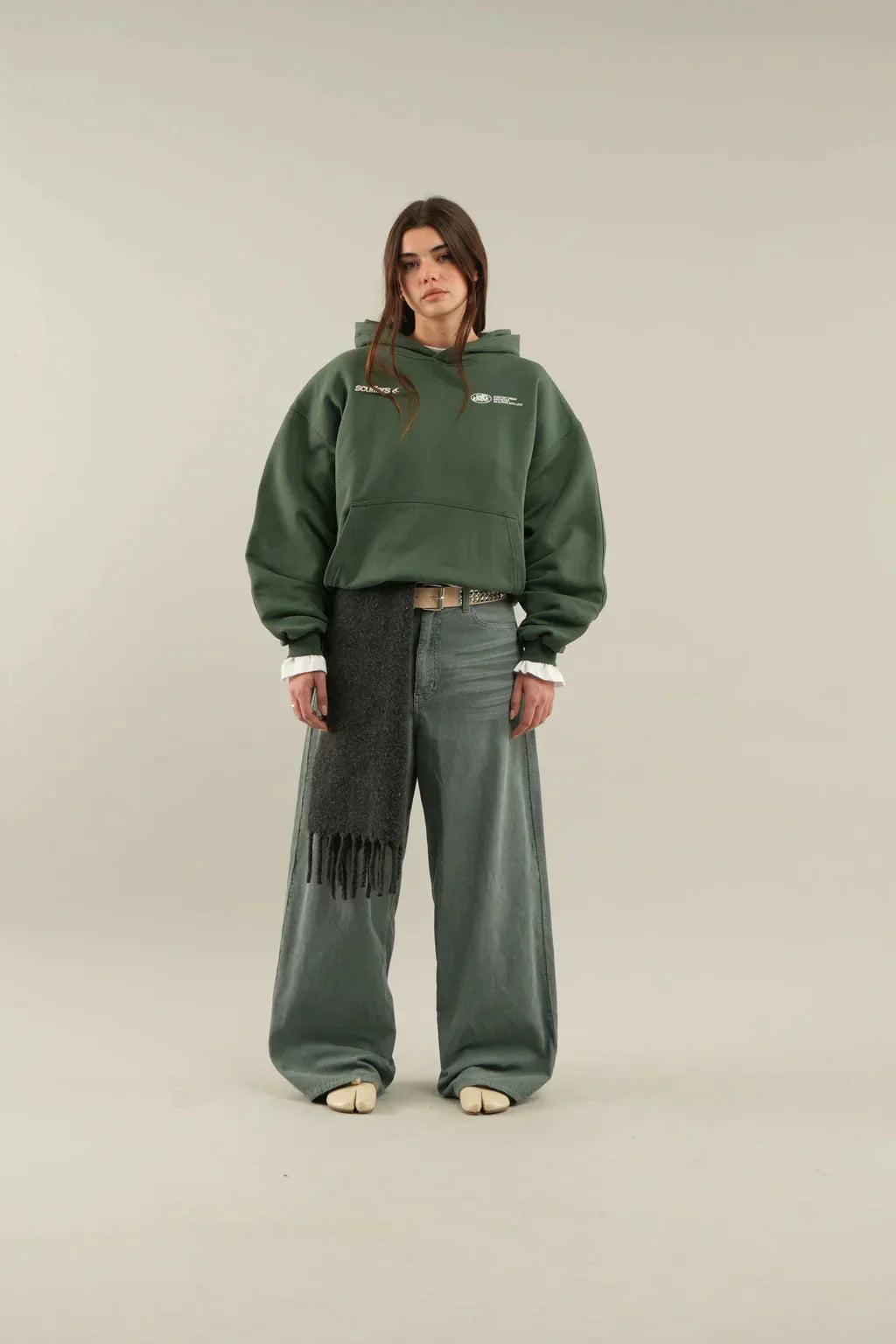 Women's oversized hoodie in casual styling with trainers and jeans