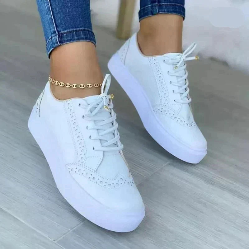 Women's platform trainers with decorative perforations and cushioned sole for casual wear