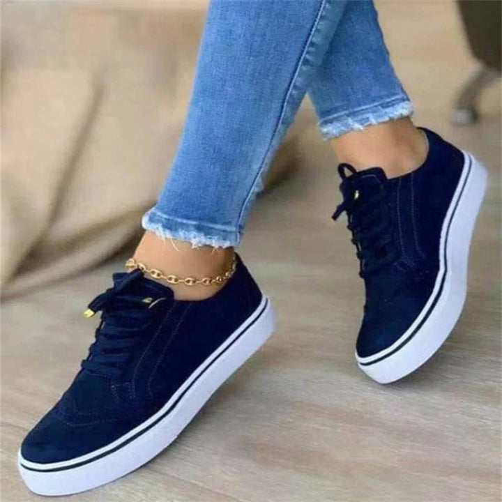 Detail of women's platform trainers showing lace-up closure and brogue-inspired design