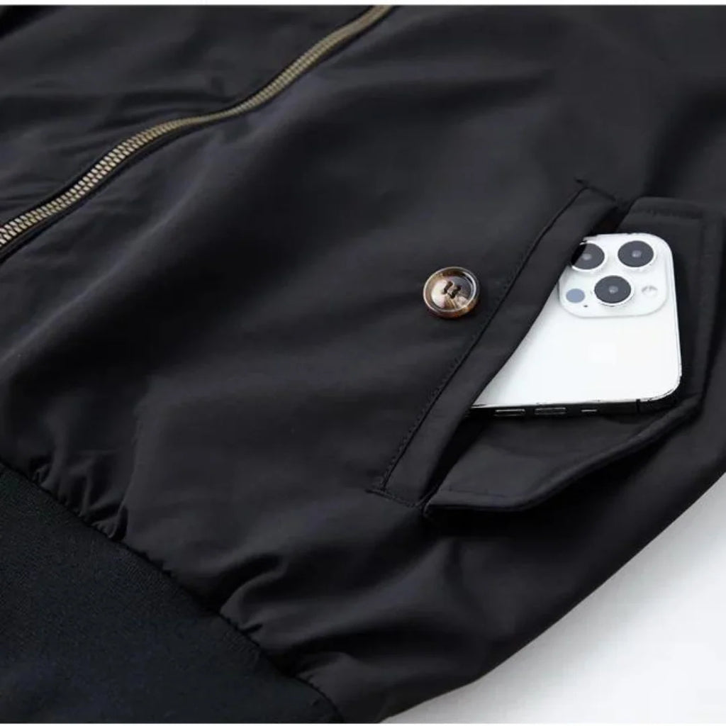 Men's navy Harrington jacket showing tartan interior lining and double-button stand collar detail