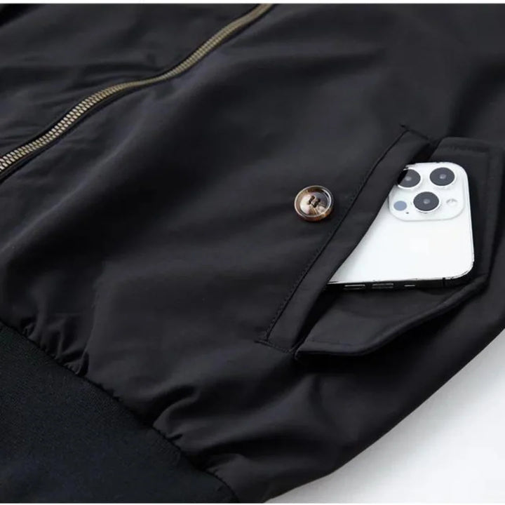 Men's navy Harrington jacket showing tartan interior lining and double-button stand collar detail