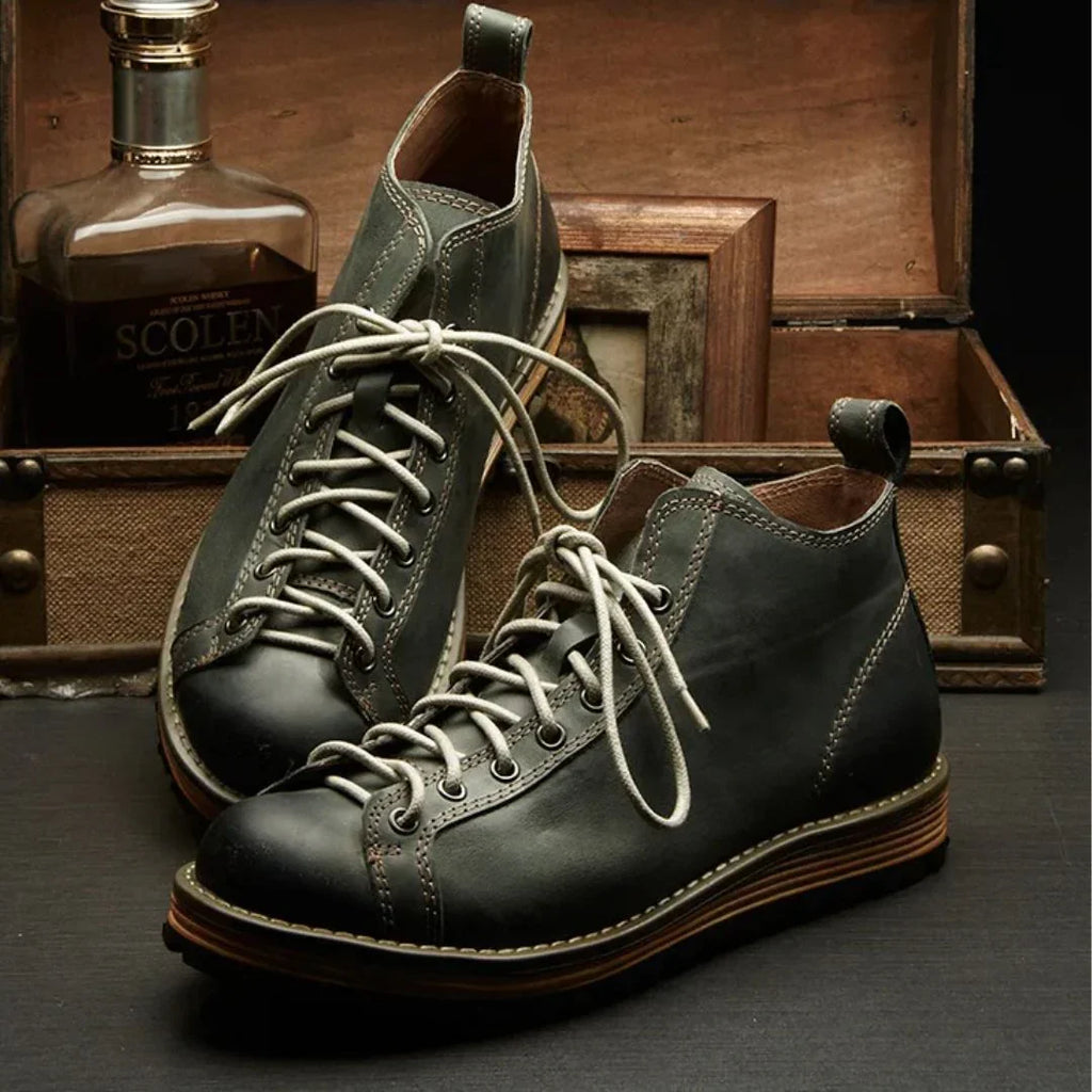 Side view of men's hiking boots showing mid-ankle height and contrast stitching detail