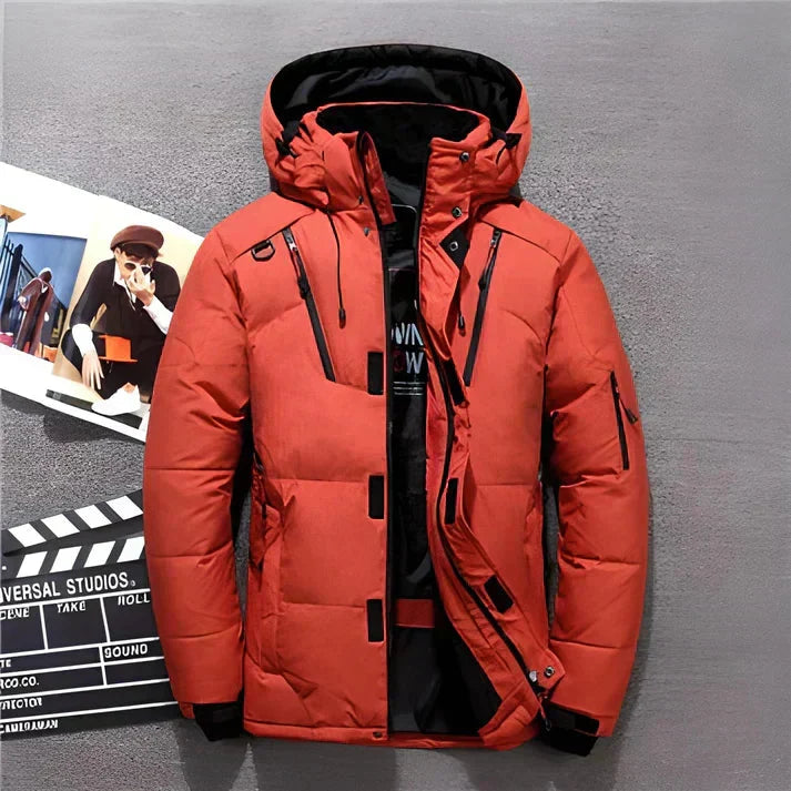 Men's hooded puffer jacket in coral-red with quilted panels and multiple zip pockets