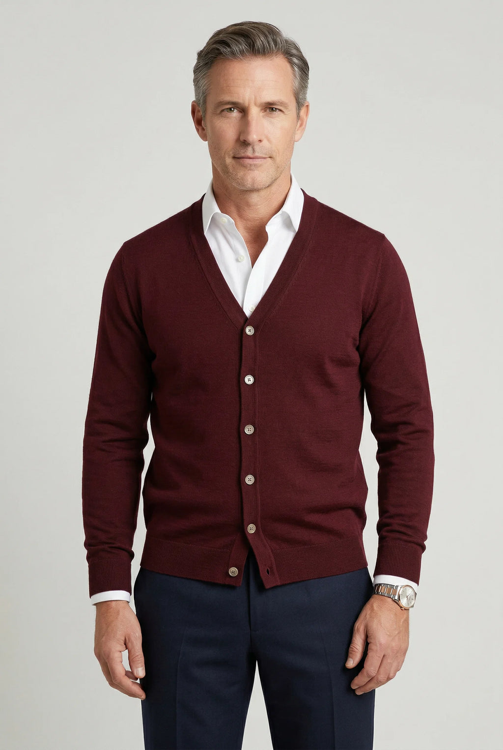 Men's knit cardigan in burgundy with V-neck and button fastening worn over white shirt