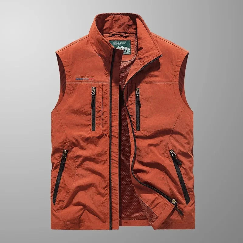 Men's multi-pocket gilet in burnt orange with stand collar and contrast zip pockets