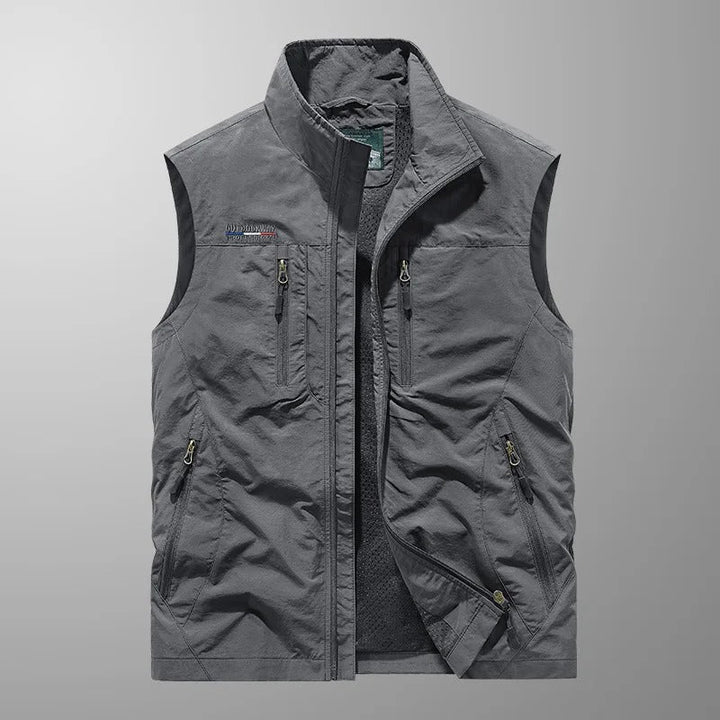 Close-up of multi-pocket gilet chest pockets with contrast zip detailing and embroidered logo