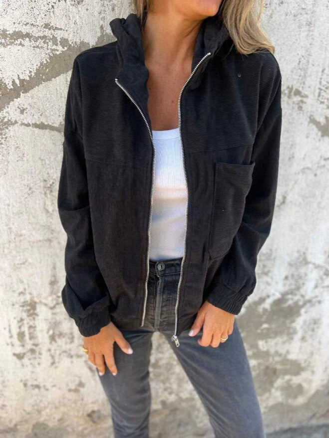 Detail shot of women's corduroy hooded jacket showing zip closure and soft ribbed hem