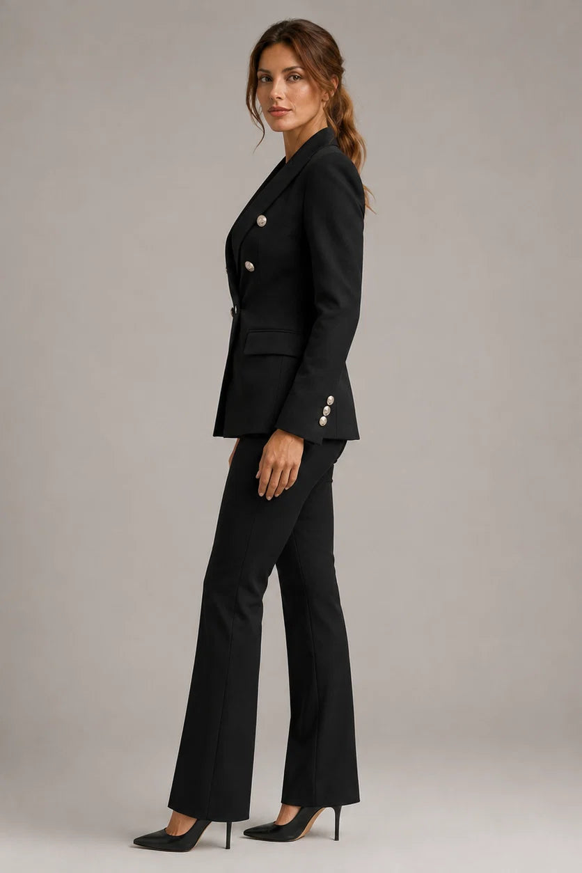 Side view of structured blazer showing flap pockets and straight-leg trousers with pressed crease