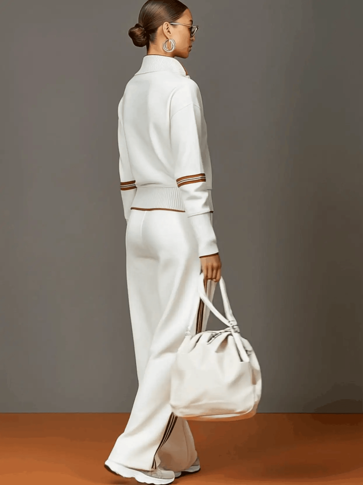 Side view of wide leg tracksuit trousers with retro stripe running down the seam