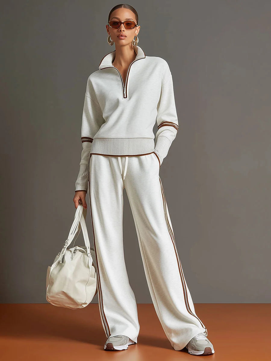 Full-length view of coordinated two-piece tracksuit set in cream with sporty accents