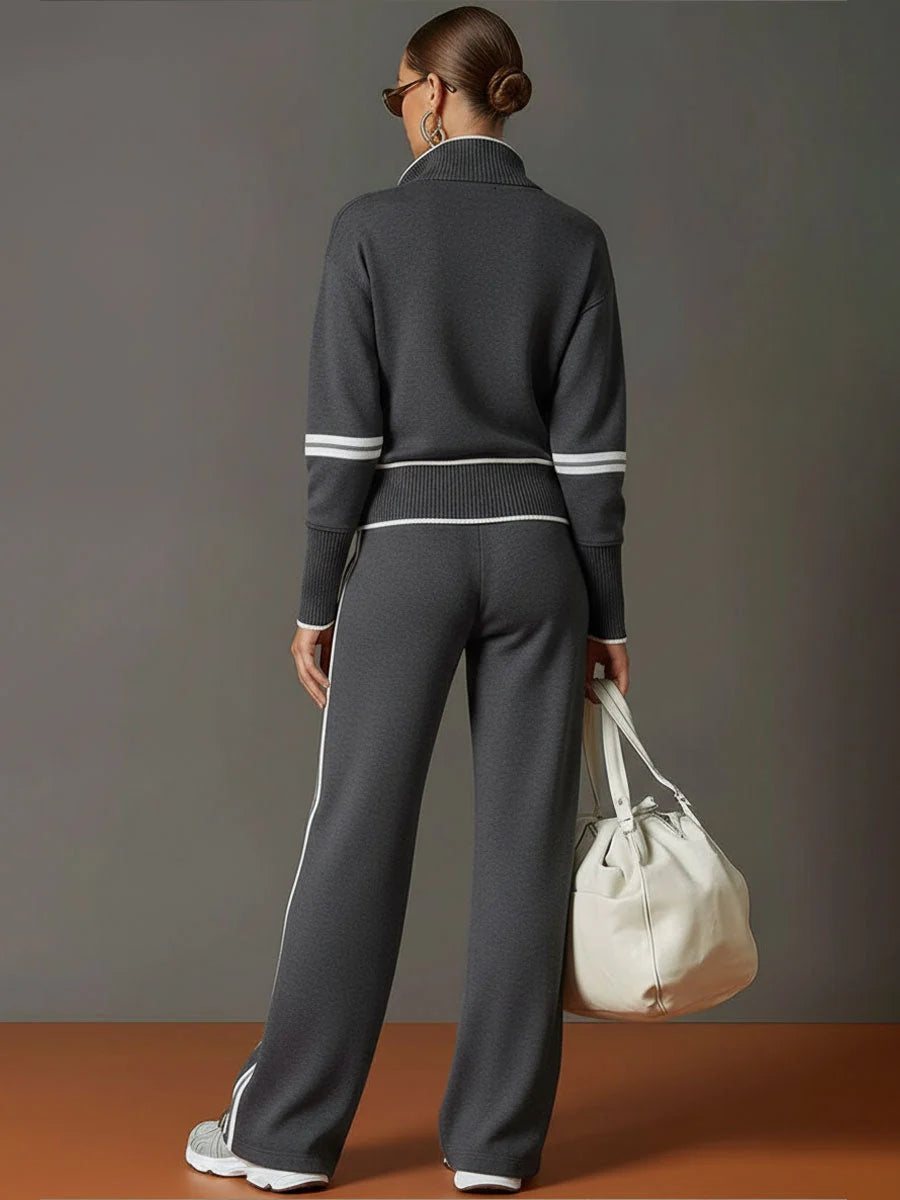 Woman styling tracksuit jumper with half-zip open over casual trousers for relaxed look