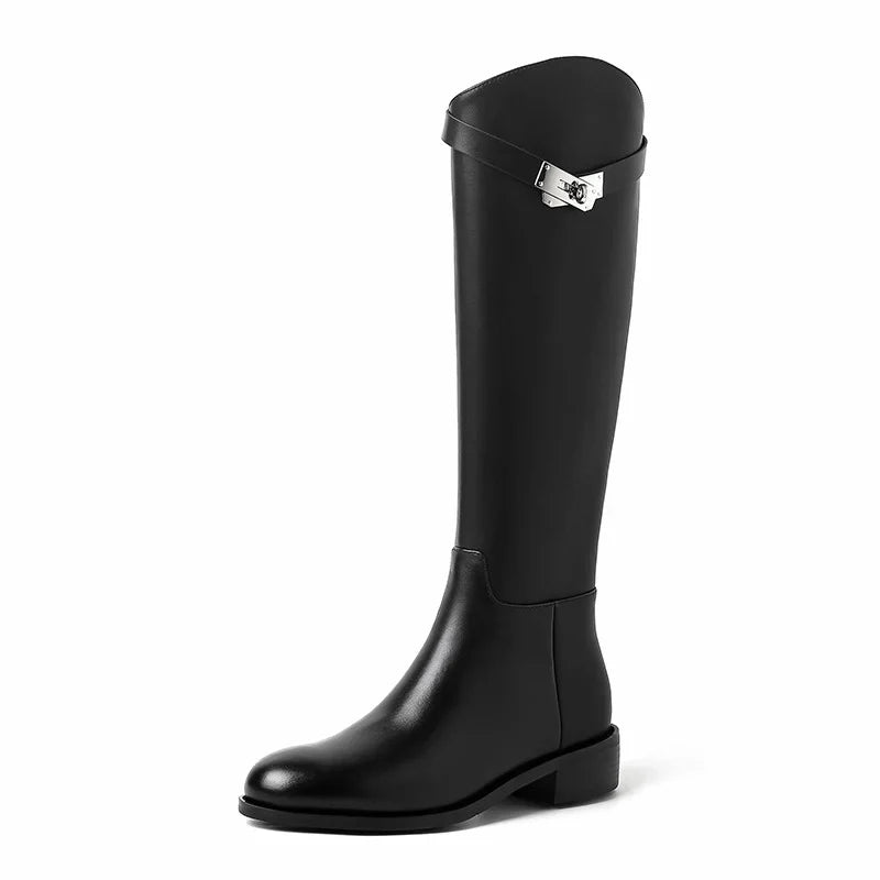 Close-up of decorative silver-tone hardware accent on knee high boot shaft