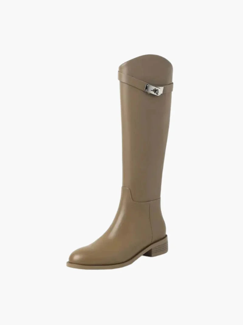 Full length view of women's knee high boots with polished surface and structured silhouette