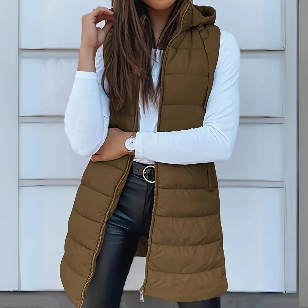 Close-up view of black hooded puffer gilet showing quilted panelling and sleeveless silhouette