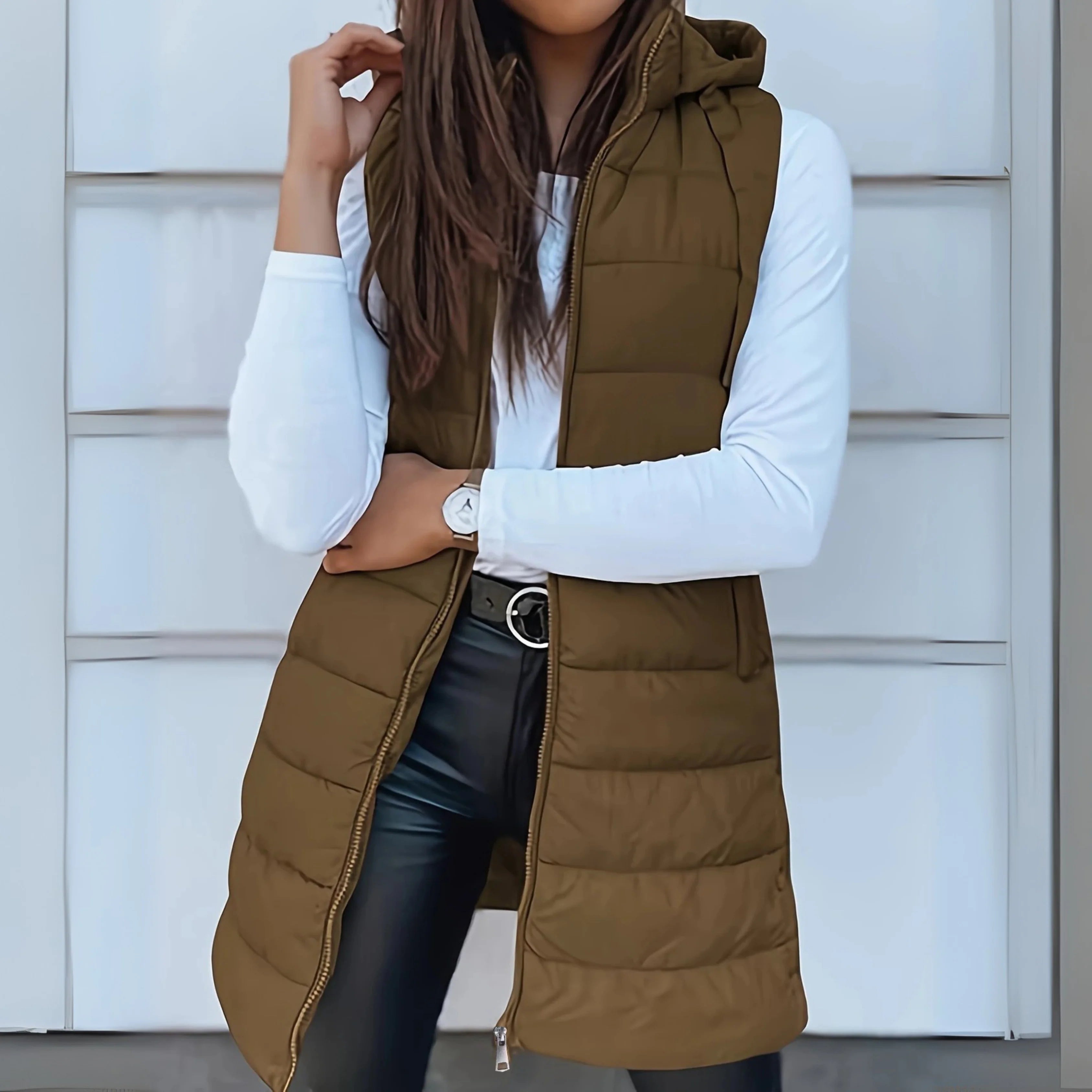 Close-up view of black hooded puffer gilet showing quilted panelling and sleeveless silhouette