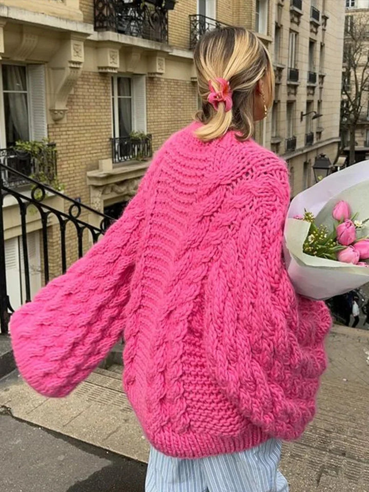 Woman styling oversized cable knit jumper with tights for casual autumn layering look