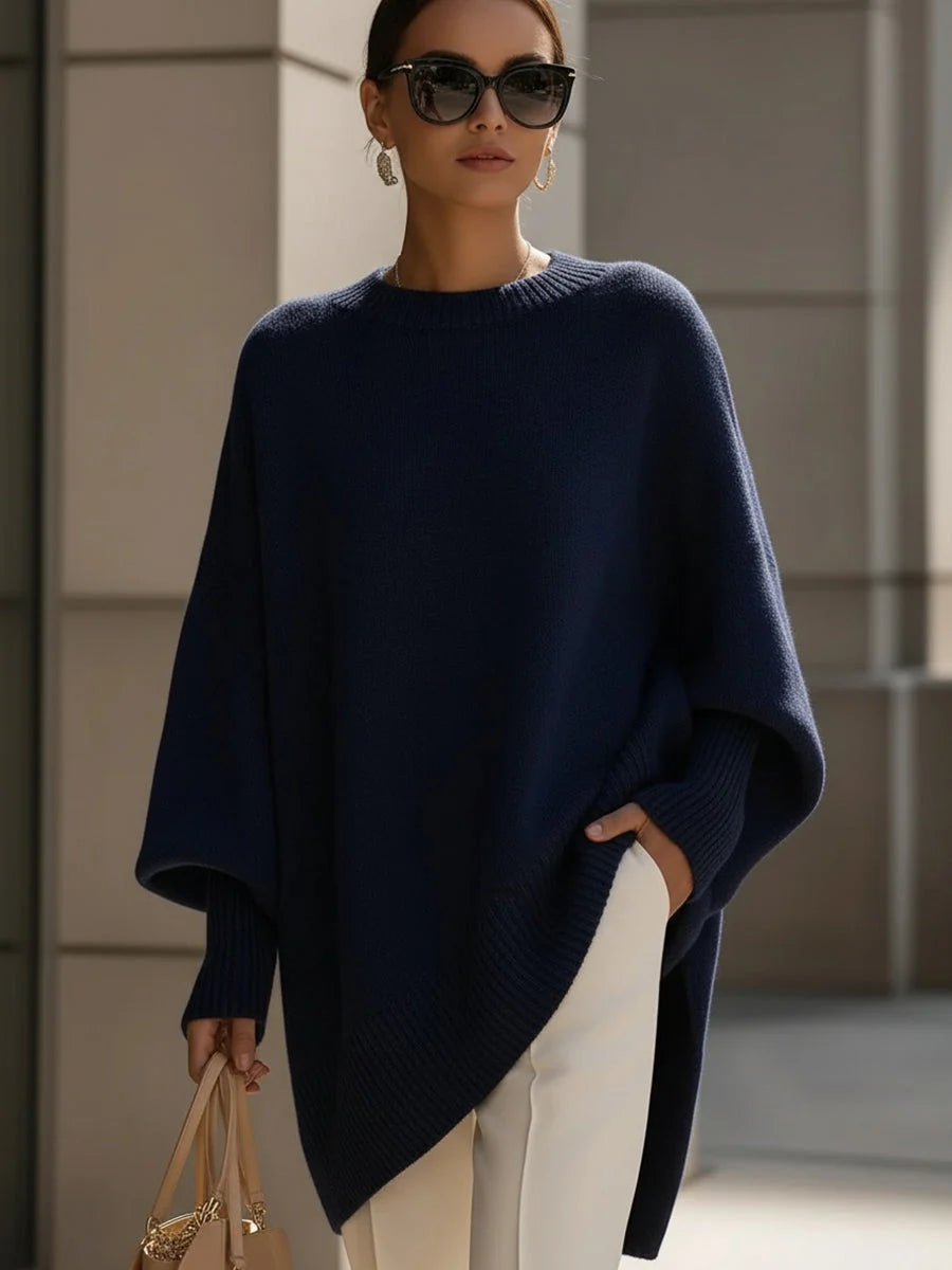 Full-length view of oversized knit jumper showing wide crew neckline and flowing drape