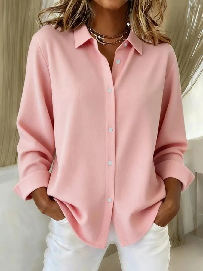 Close-up view of women's oversized shirt showing relaxed fit and smooth fabric texture with cuffed sleeves