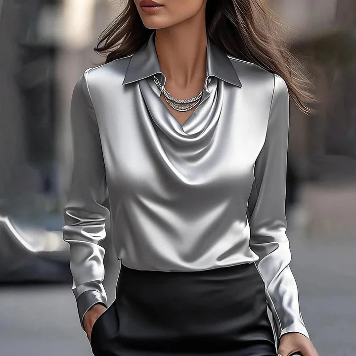 Side view of women's satin blouse featuring long sleeves and structured collar with elegant drape
