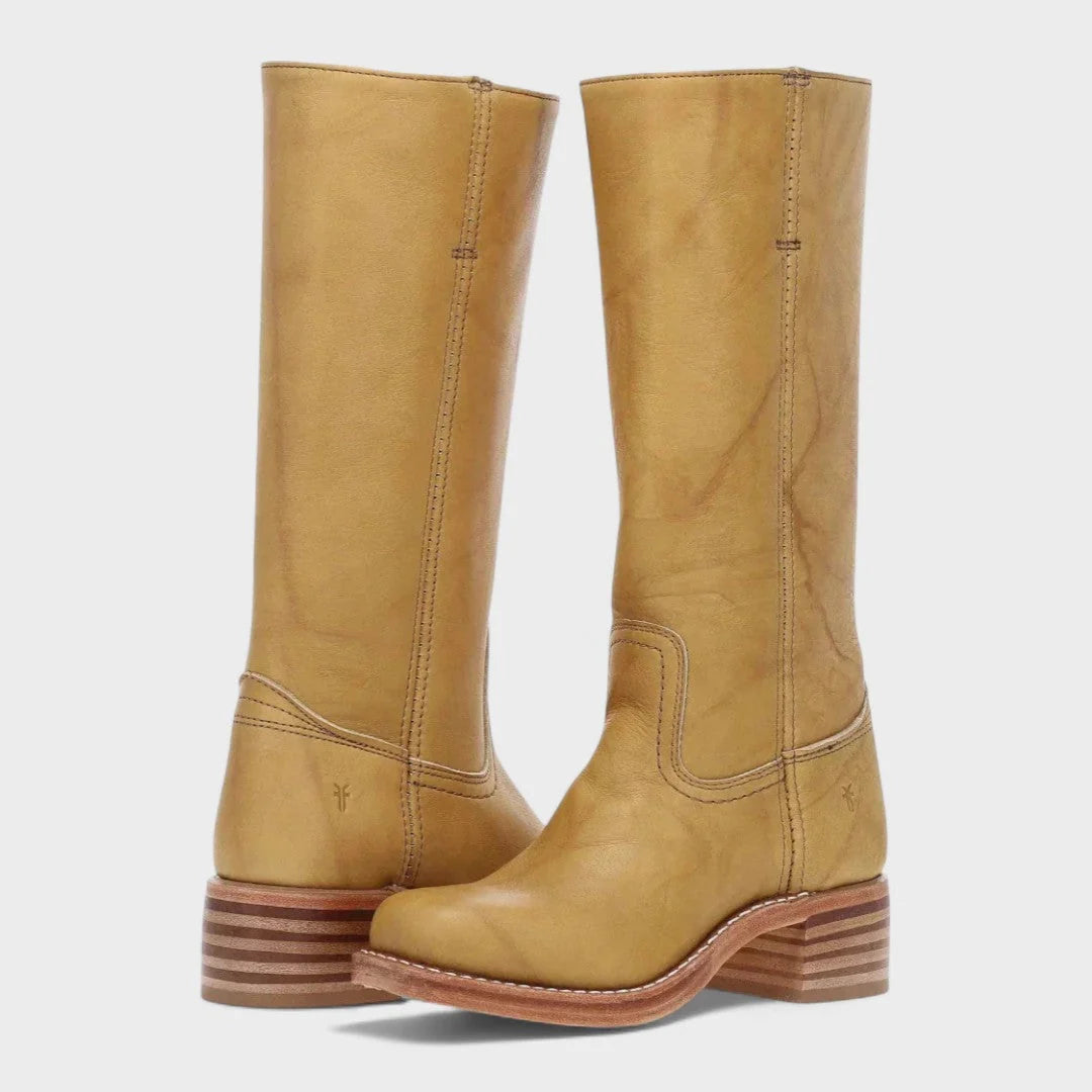 Close-up of women's tall boots featuring smooth finish and structured heel counter detail