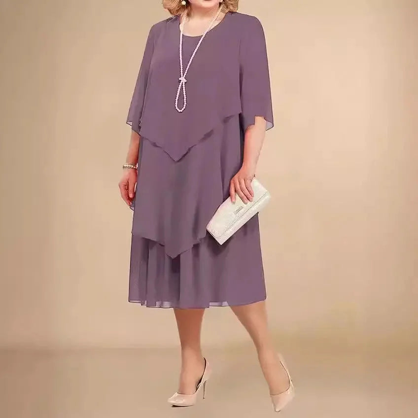 Side view of layered midi dress showing relaxed silhouette and elbow-length sleeves for formal occasions