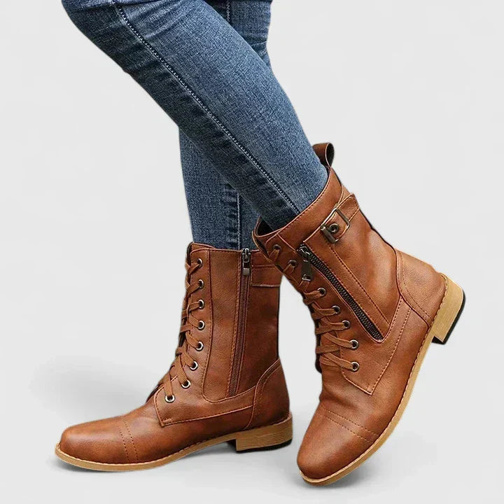Side view of black lace-up combat boots with low block heel and zip fastening