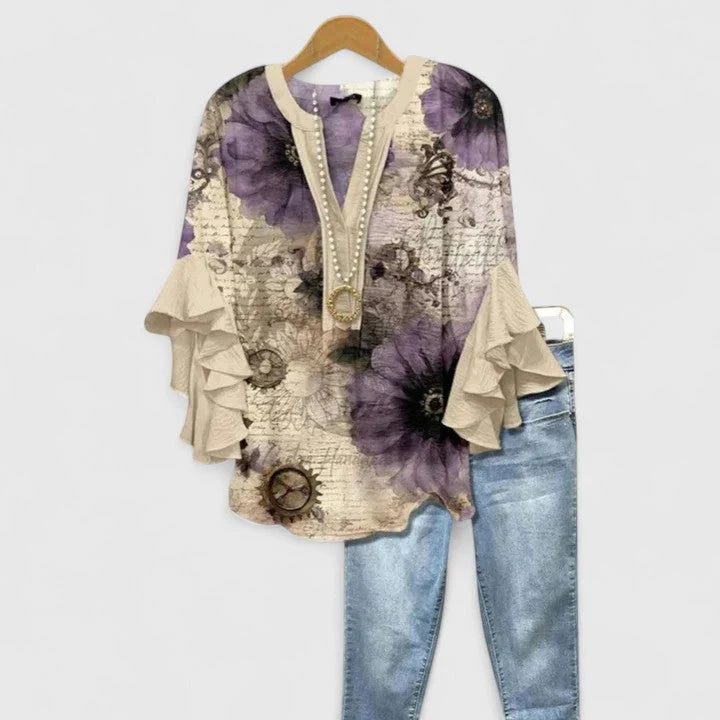 Styled look featuring floral print blouse with casual denim trousers