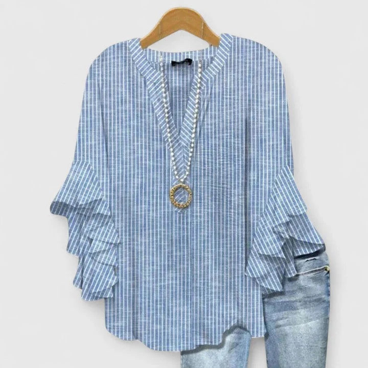 Side view of women's blouse with ruffled three-quarter sleeves and relaxed fit