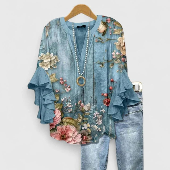 Women's blouse styled with jeans showing relaxed fit through body