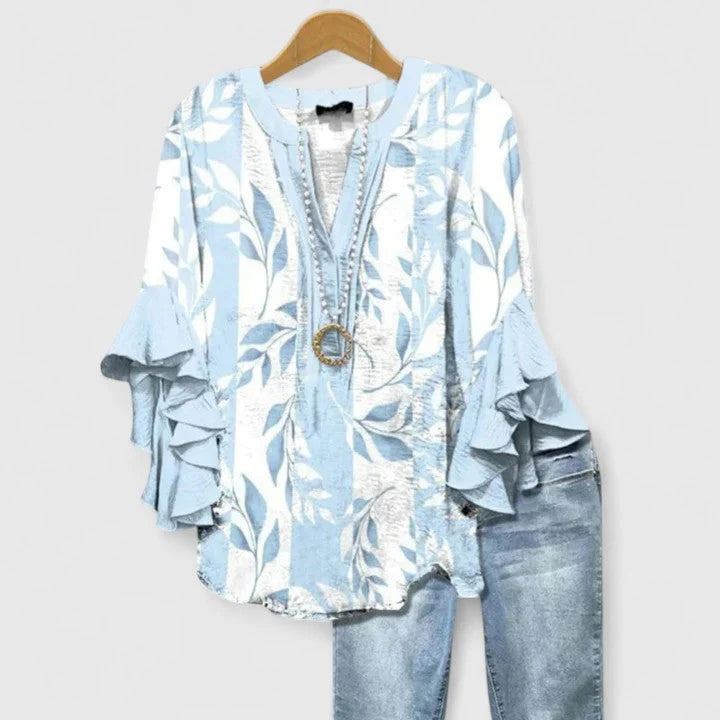 Close-up of ruffled sleeve detail on floral print blouse