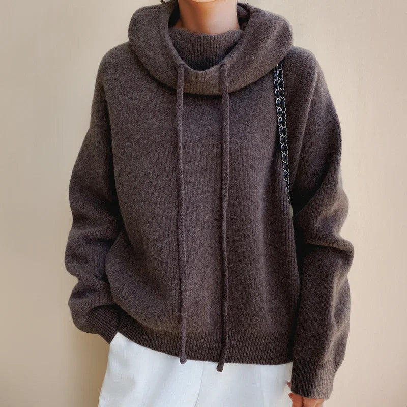 Women's hooded knit jumper in brown with drawstring hood and relaxed fit silhouette