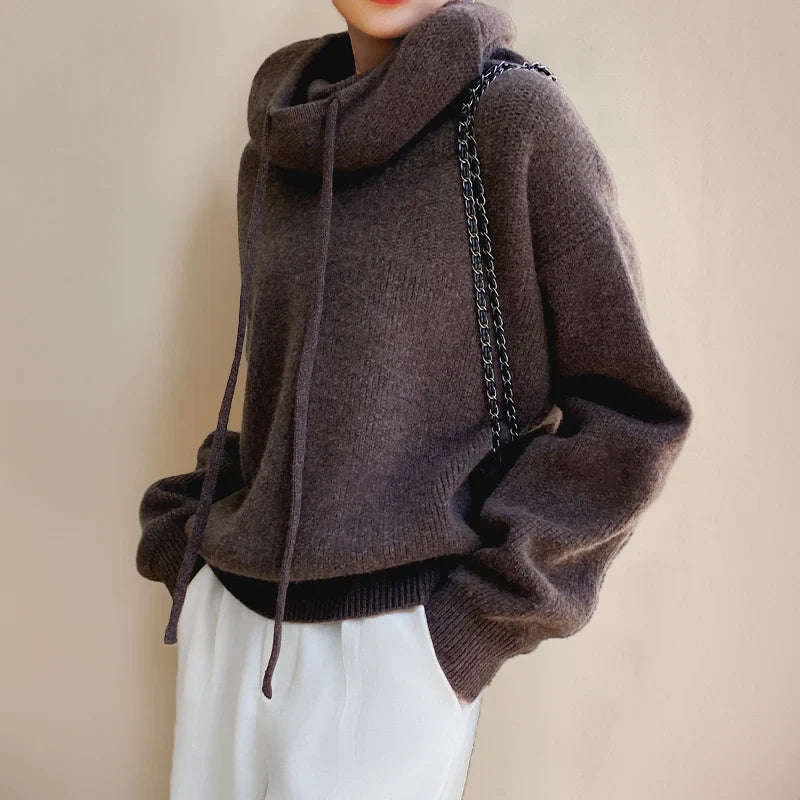 Close-up view of women's hooded knit jumper showing ribbed trims and soft knit texture