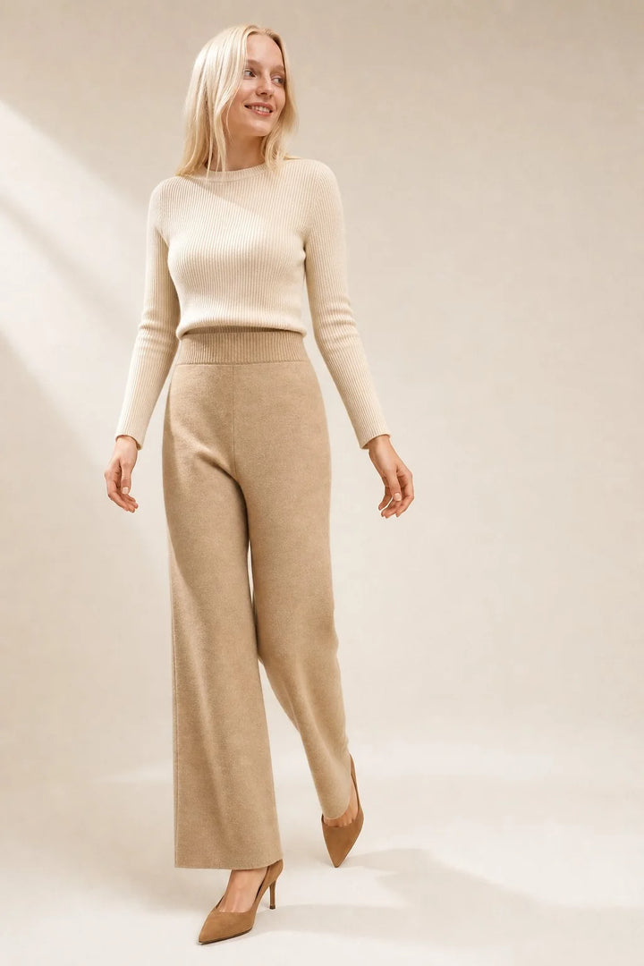 Woman seated in mohair lounge set showing elasticated waistband and flared leg design
