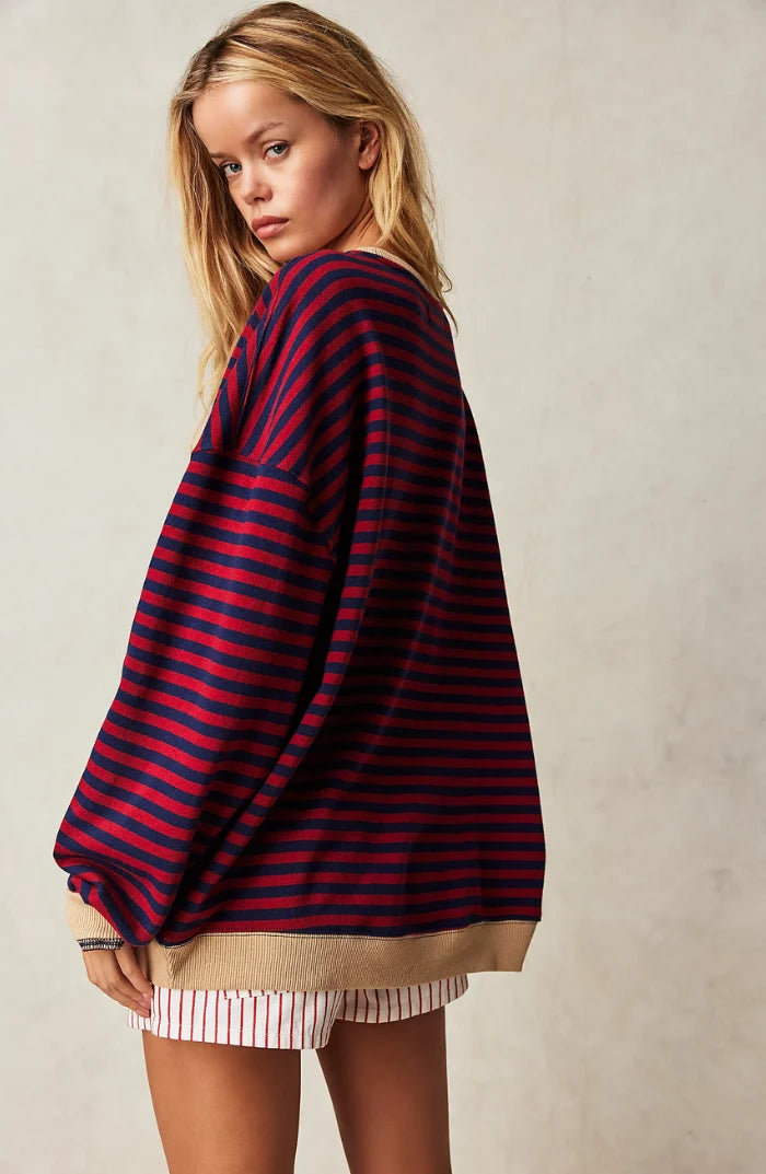Detail of neckline and contrast trim on women's oversized striped jumper