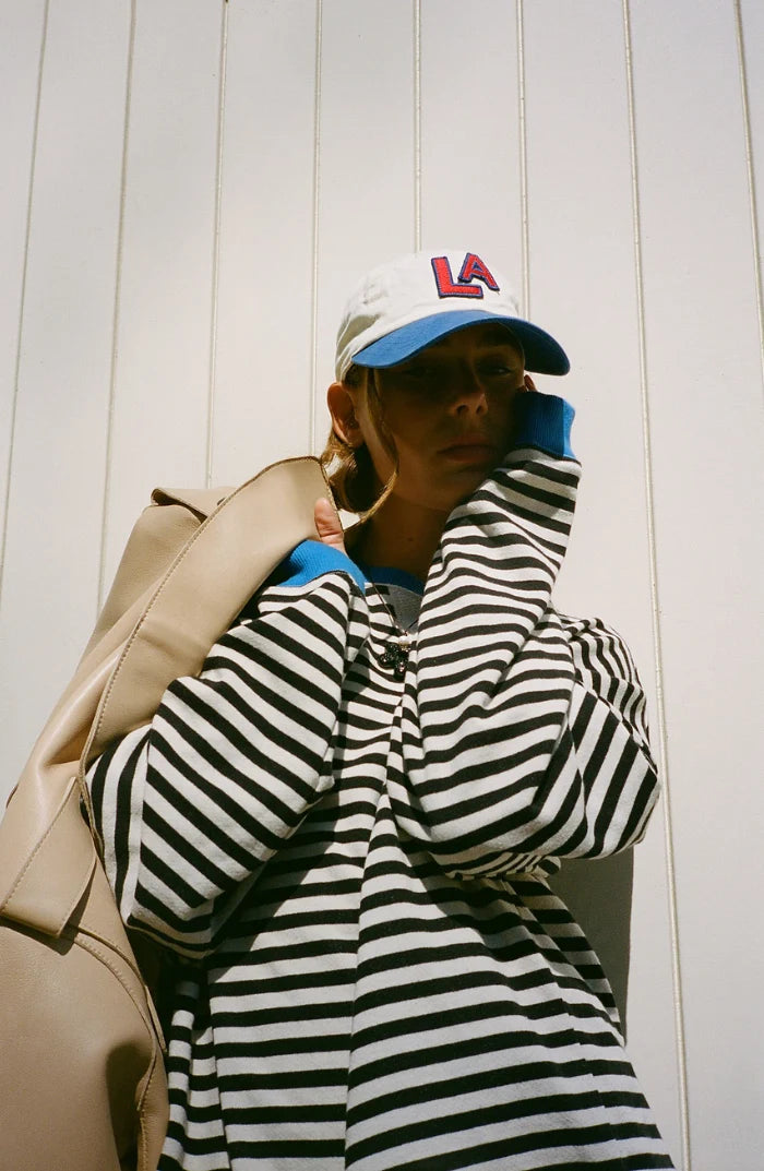 Women's oversized striped jumper styled casually for weekend wear with relaxed silhouette