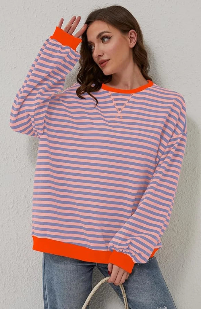 Women's oversized striped jumper styled with jeans, showing relaxed fit and boxy silhouette