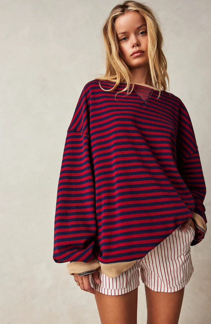Women's oversized striped jumper showing wide sleeves and relaxed drop shoulder construction