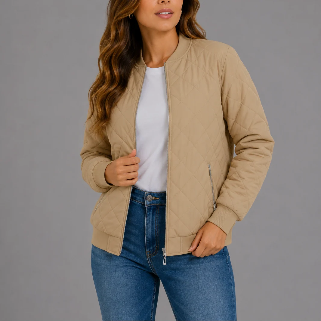 Woman wearing the quilted bomber jacket layered over casual daywear for spring styling