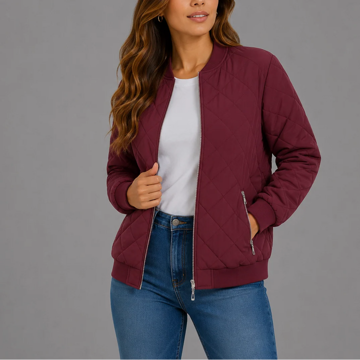 Close-up view of the diamond-quilted pattern and zip-front closure on a women's bomber jacket
