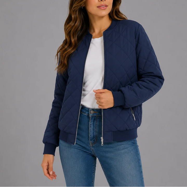 Close-up of the zip-front closure and ribbed neckline detail on the quilted bomber